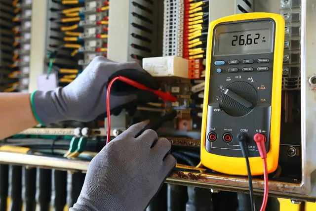 Multimeter being used to trace a fault on the terminals of an electrical panel